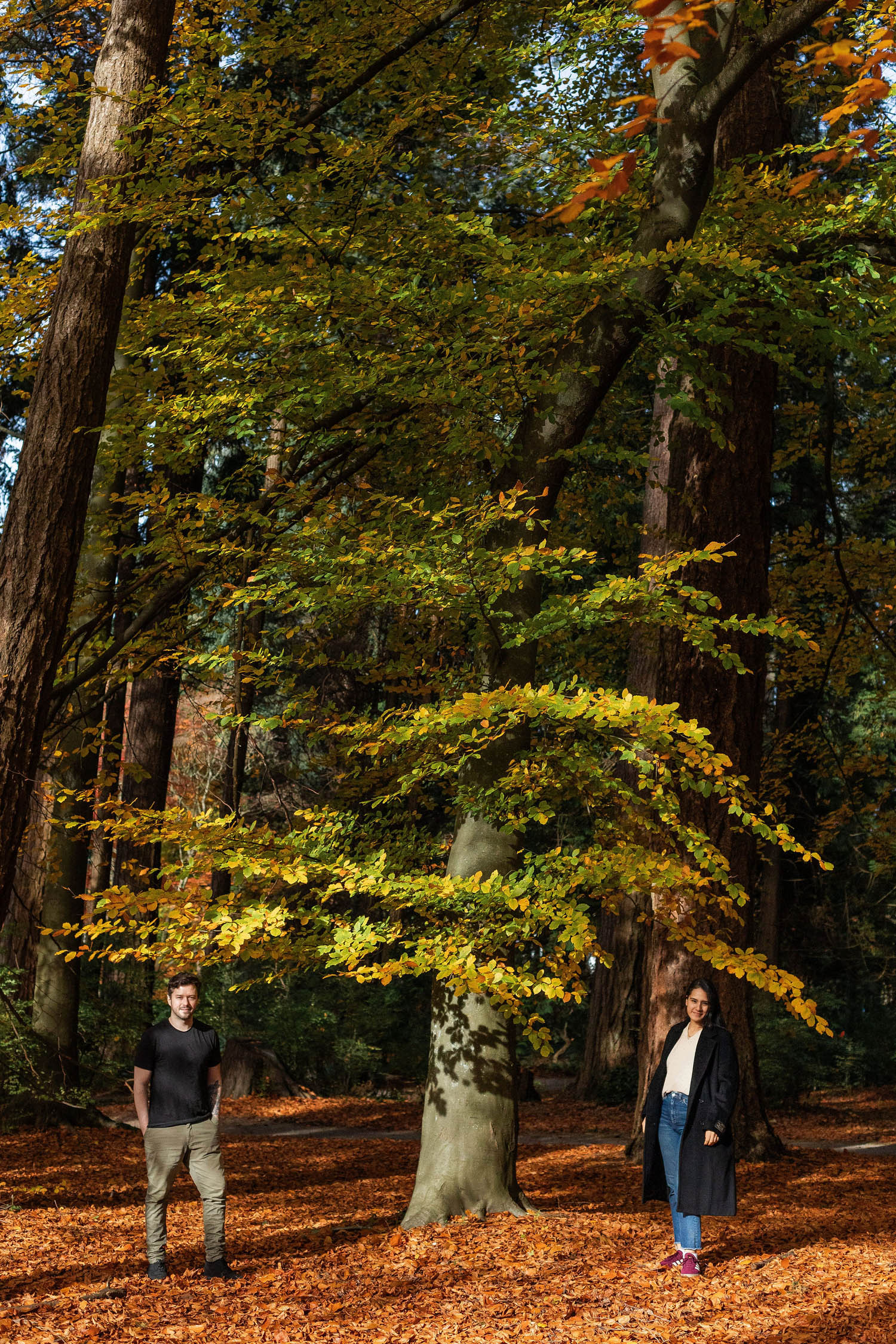 couple striking a stance at vancouver engagement session in autumn