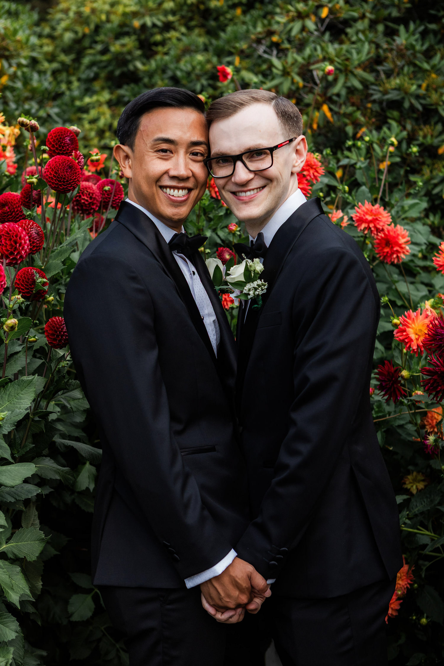 portrait of grooms in front of roses at stanley park