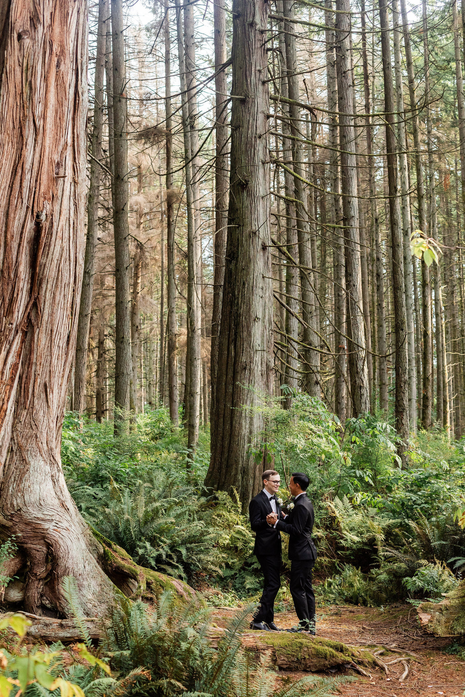 gay wedding couple in stanley park dancing in the forest