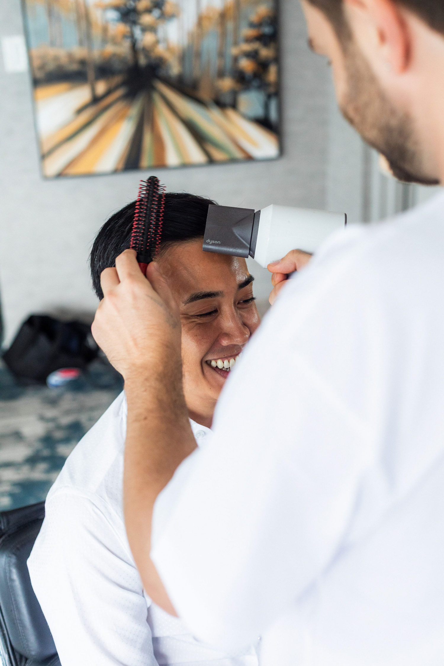 groom getting his hair done before wedding ceremony at stanley park pavilion