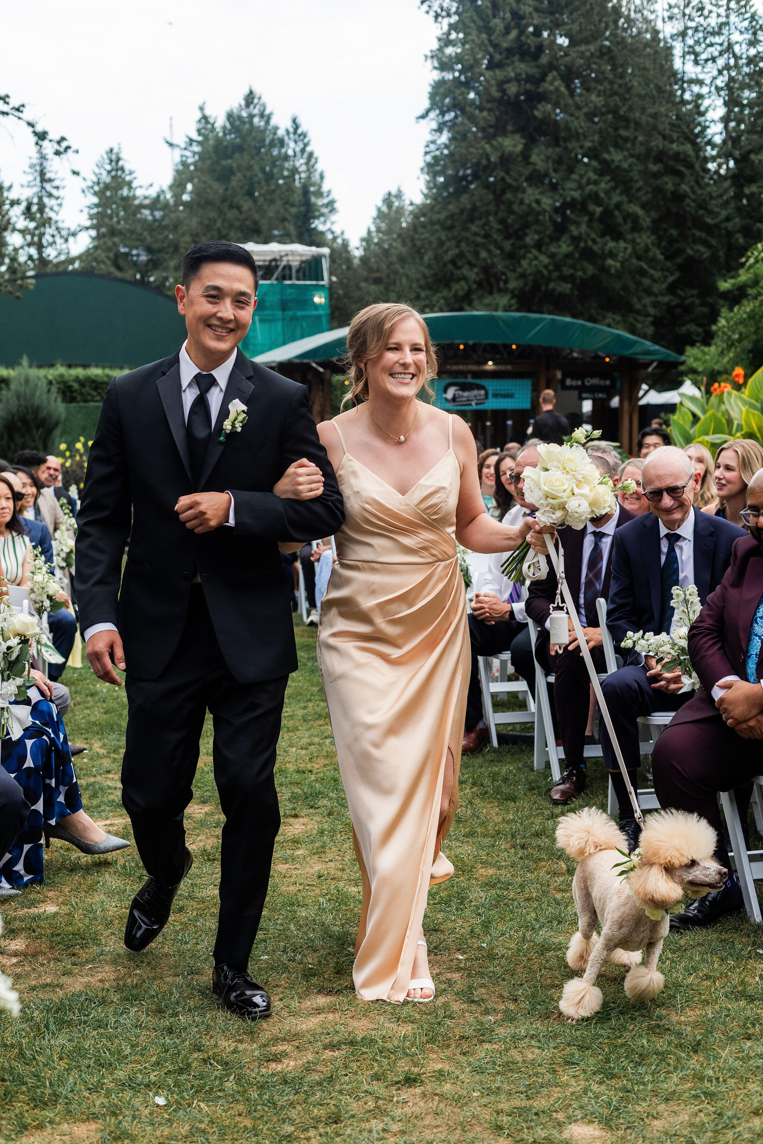 wedding party walking down aisle with poodle at stanley park pavilion ceremony
