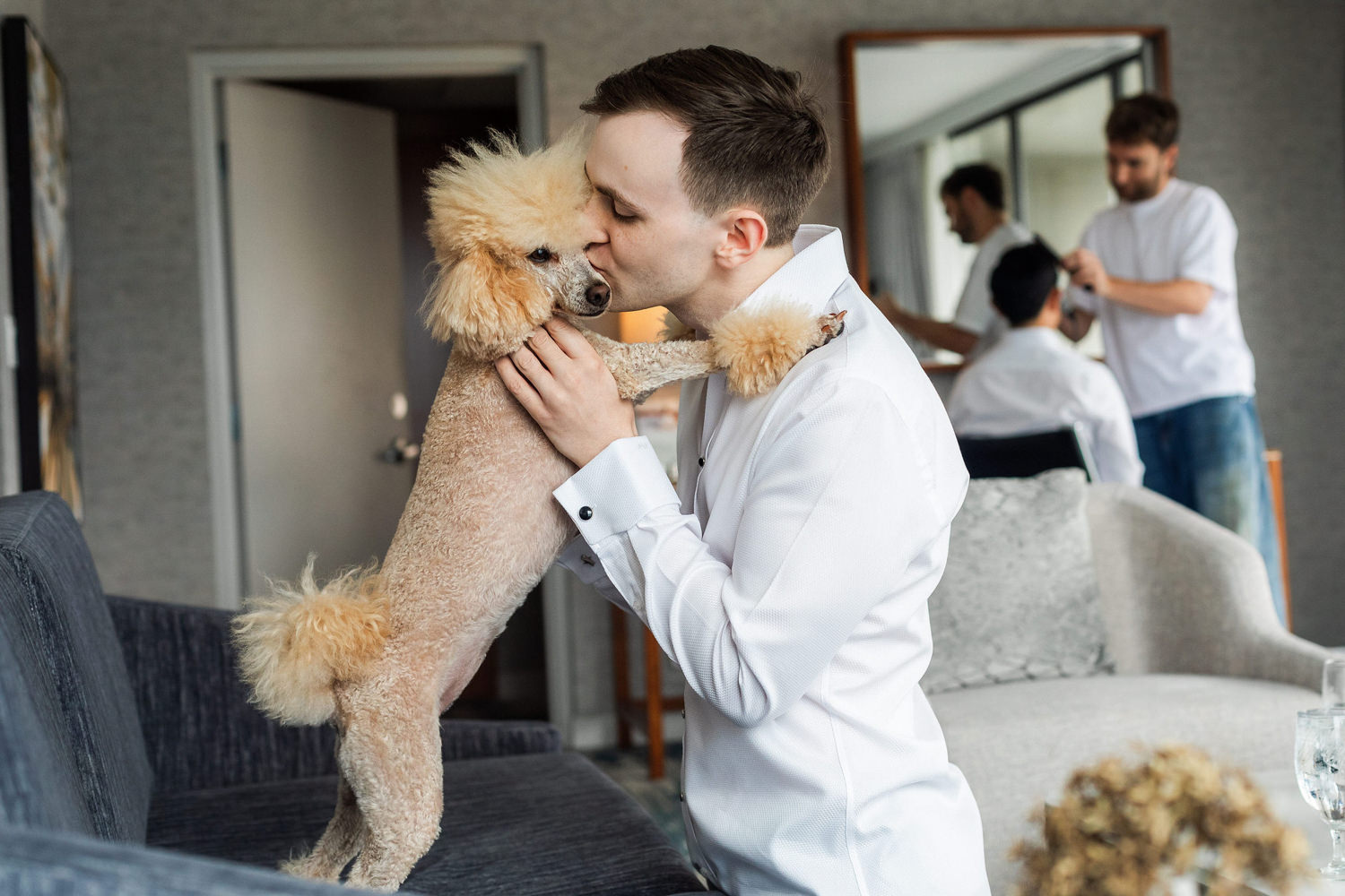 groom playing with his dog before stanley park pavilion ceremony