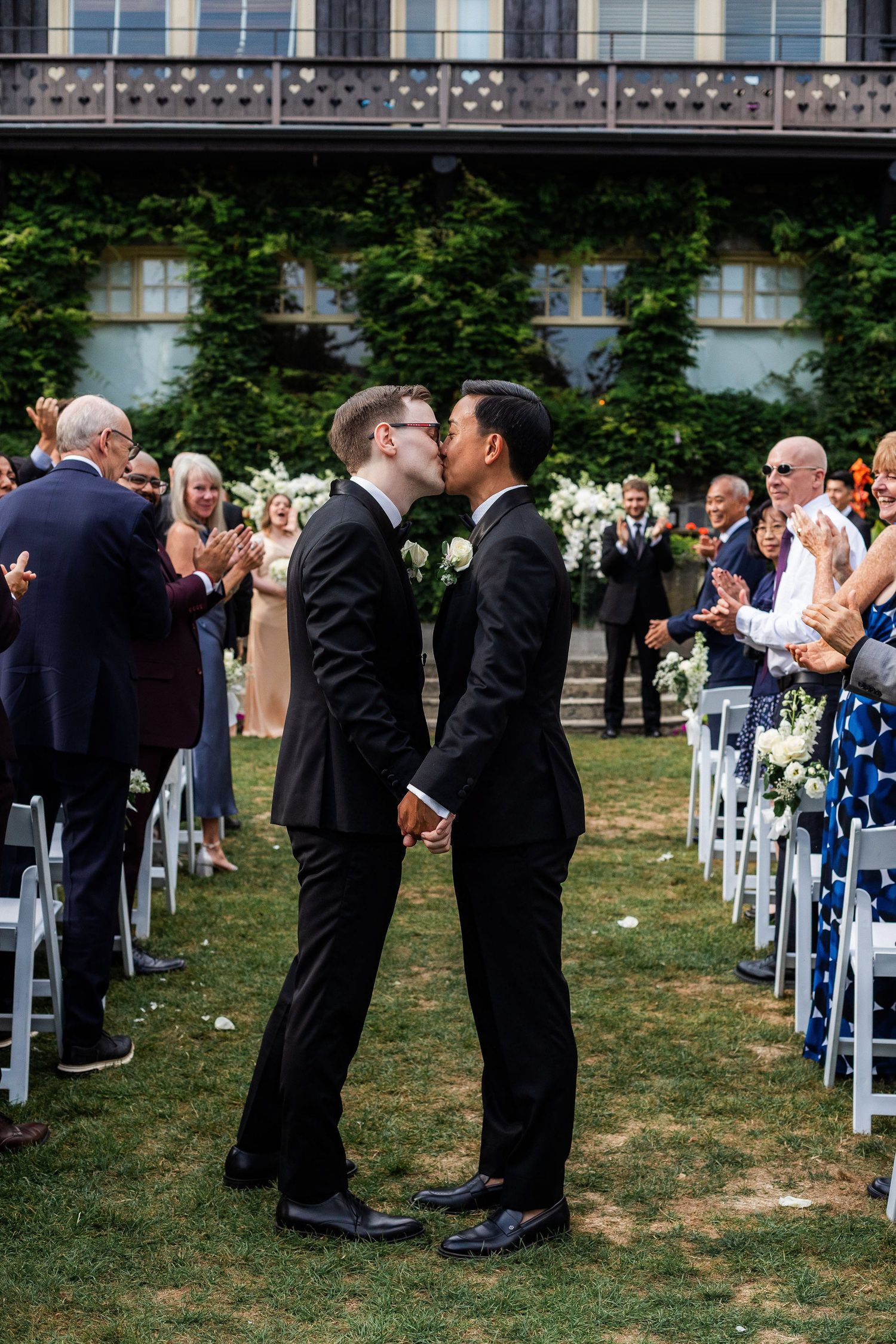 grooms kiss down the aisle at stanley park pavilion