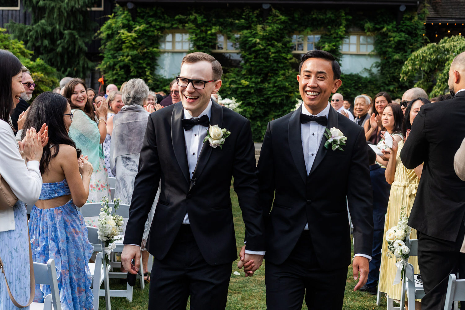 smiling grooms just married at stanley park pavilion